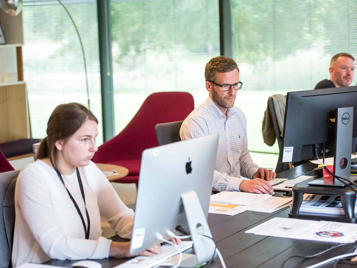 Customer service staff working at their screens in an office