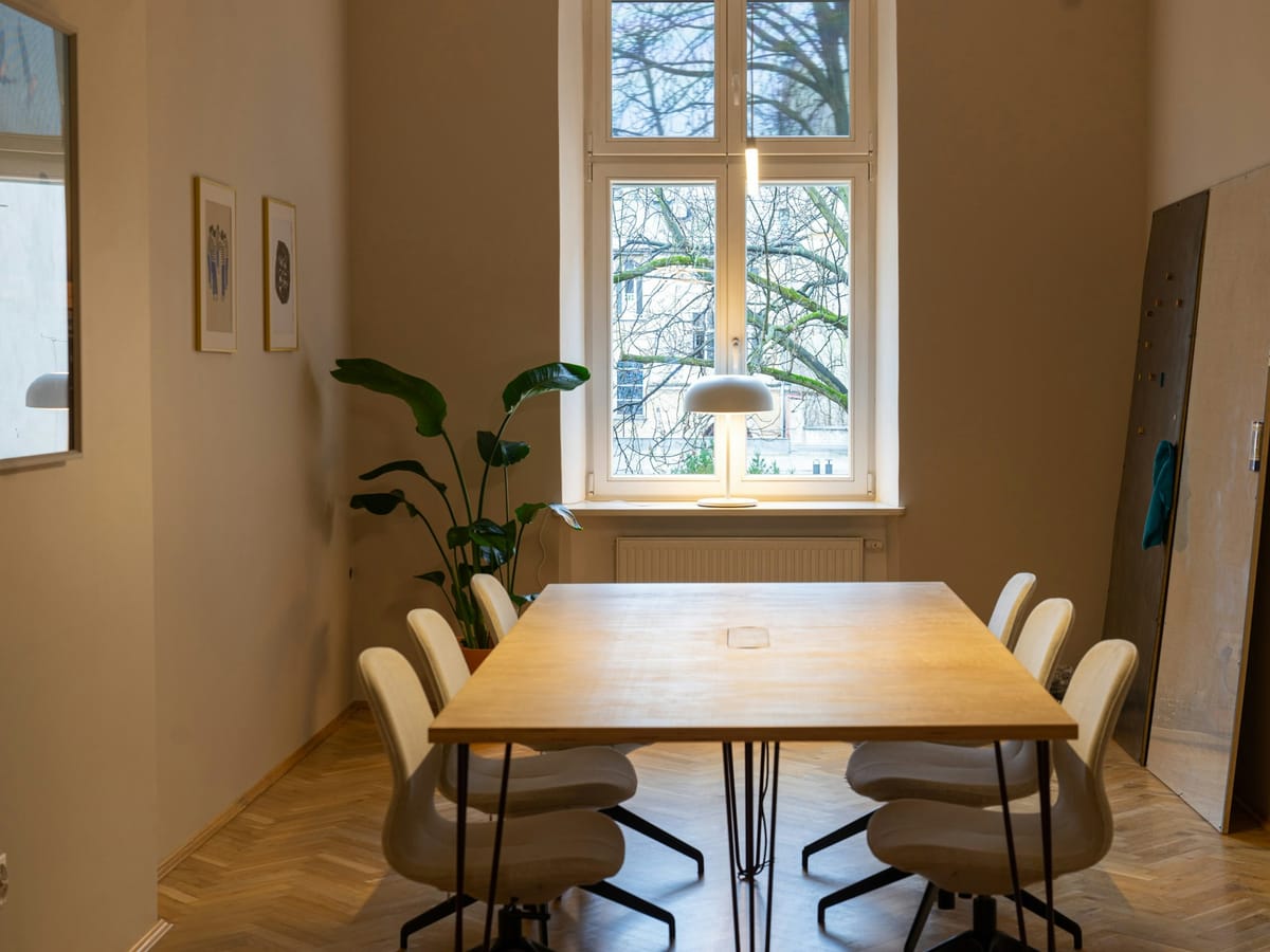 Bright meeting room with a wooden table in a coworking space