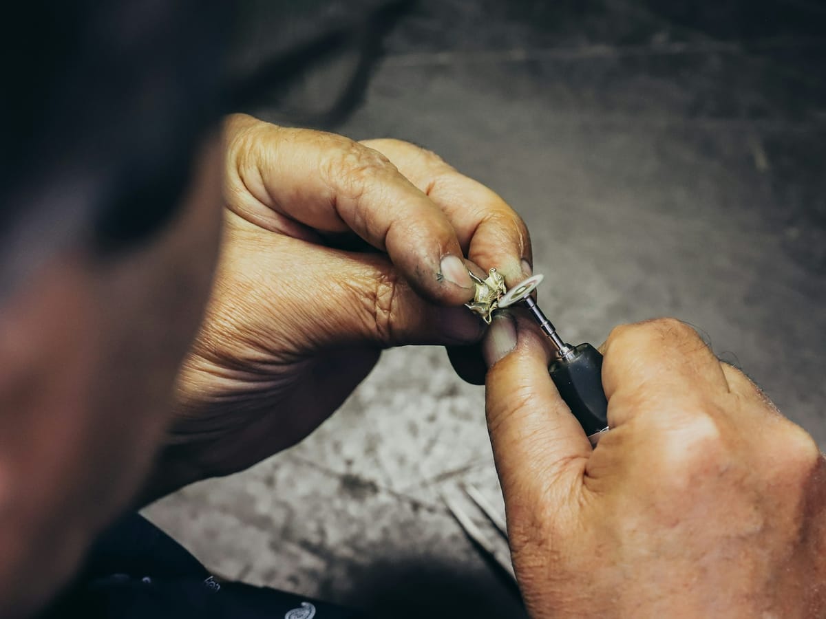 Goldsmith setting a ring at the workbench